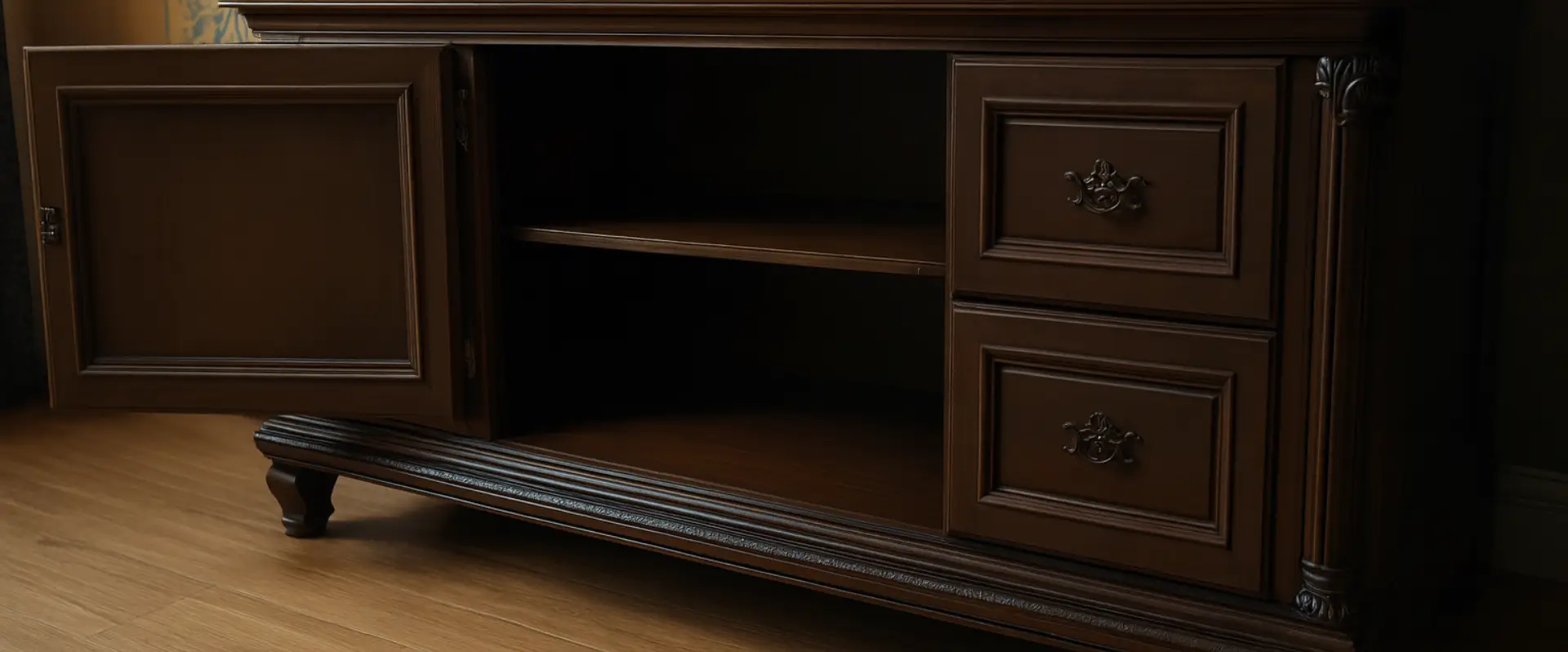 A dark wooden cabinet with two closed drawers on the right and an open cupboard door on the left, revealing empty shelves inside, standing on a wooden floorâideal for homes seeking Flood Damage Restoration solutions. A dark wooden cabinet with two closed drawers on the right and an open cupboard door on the left, revealing empty shelves inside, standing on a wooden floorâideal for homes seeking Flood Damage Restoration solutions.